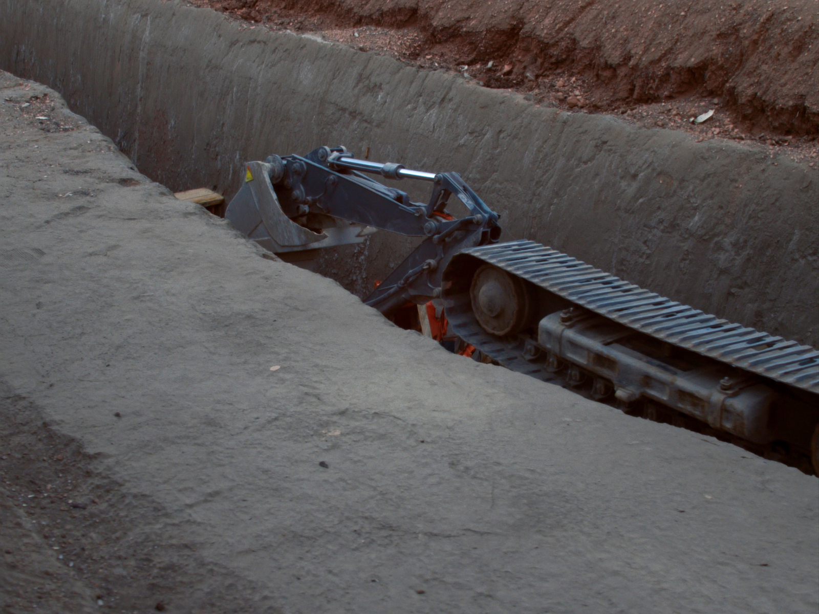 Mini excavators on a work site, the kind of load these trailers carry