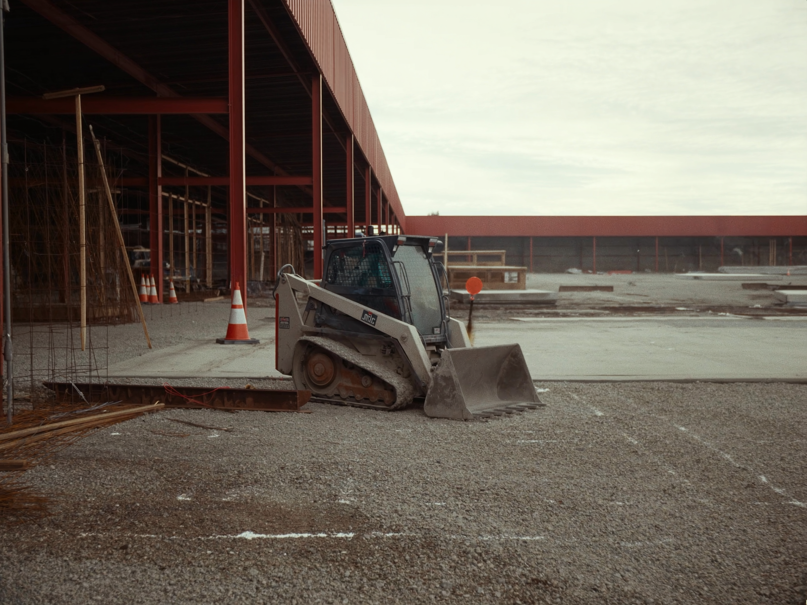 Skid steers and track loaders on a work site, the kind of load these trailers carry